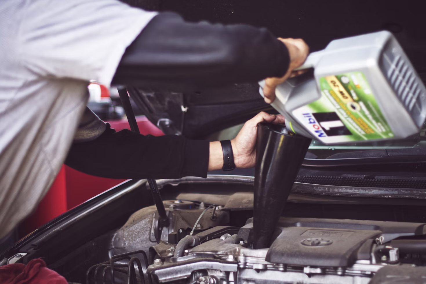 Fresh motor oil being poured into the engine